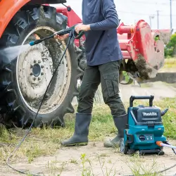 HW001GZ-MAKITA-40Vmax-Cordless-High-Pressure-Washer-1 Person using HW001GZ MAKITA 40Vmax cordless high pressure washer to clean farm equipment outdoors